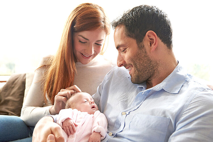 Mother And Father At Home With Newborn Baby